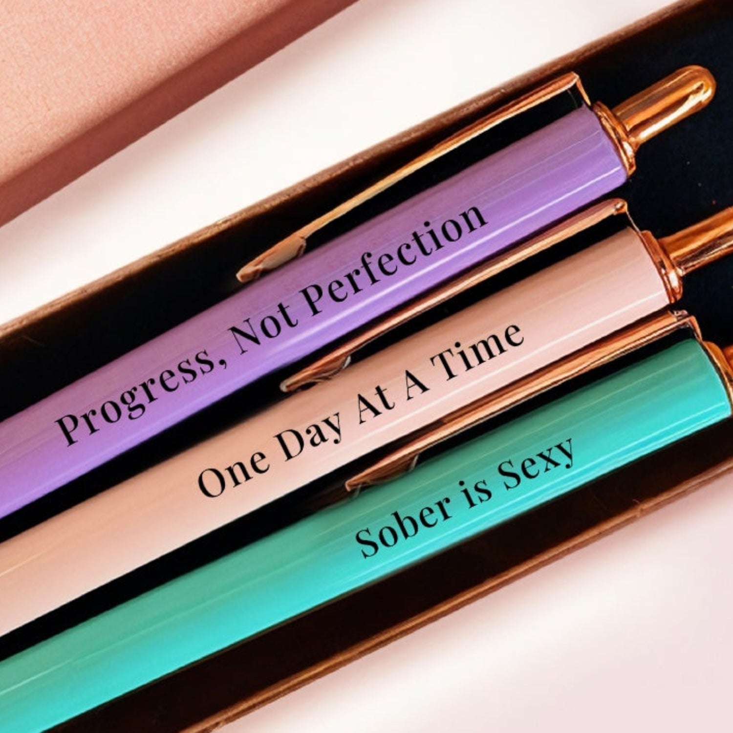 Set of three pens in a MESMOS box with text on a light pink background-2