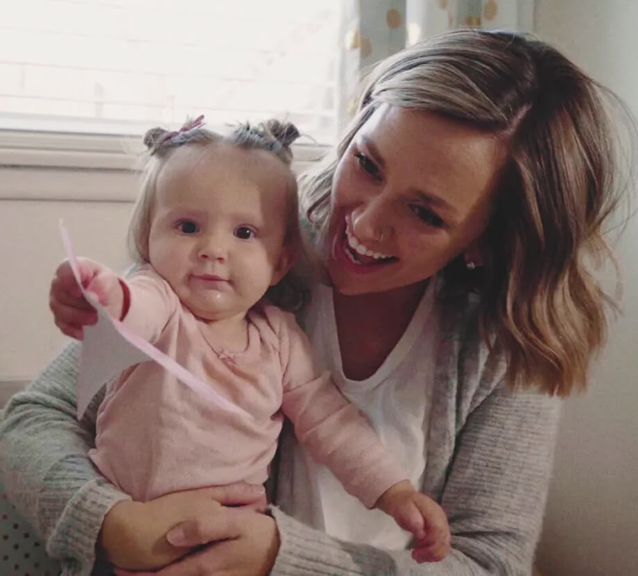 Mother holding her baby while spending a joyful moment together indoors