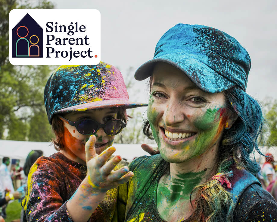 Two people with colorful paint on their faces in an outdoor setting